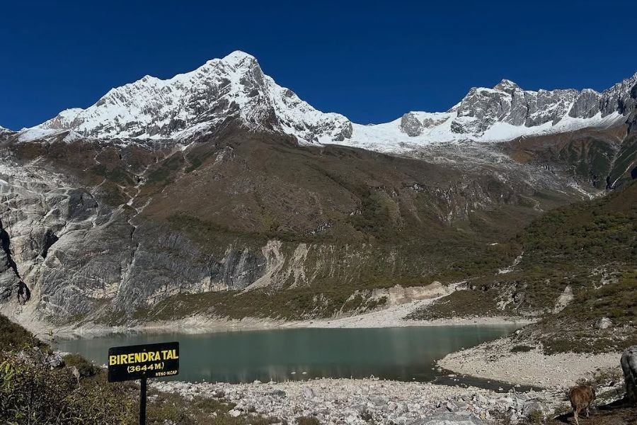 Birendra Lake with turquoise water surrounded by snow-capped Himalayan peaks